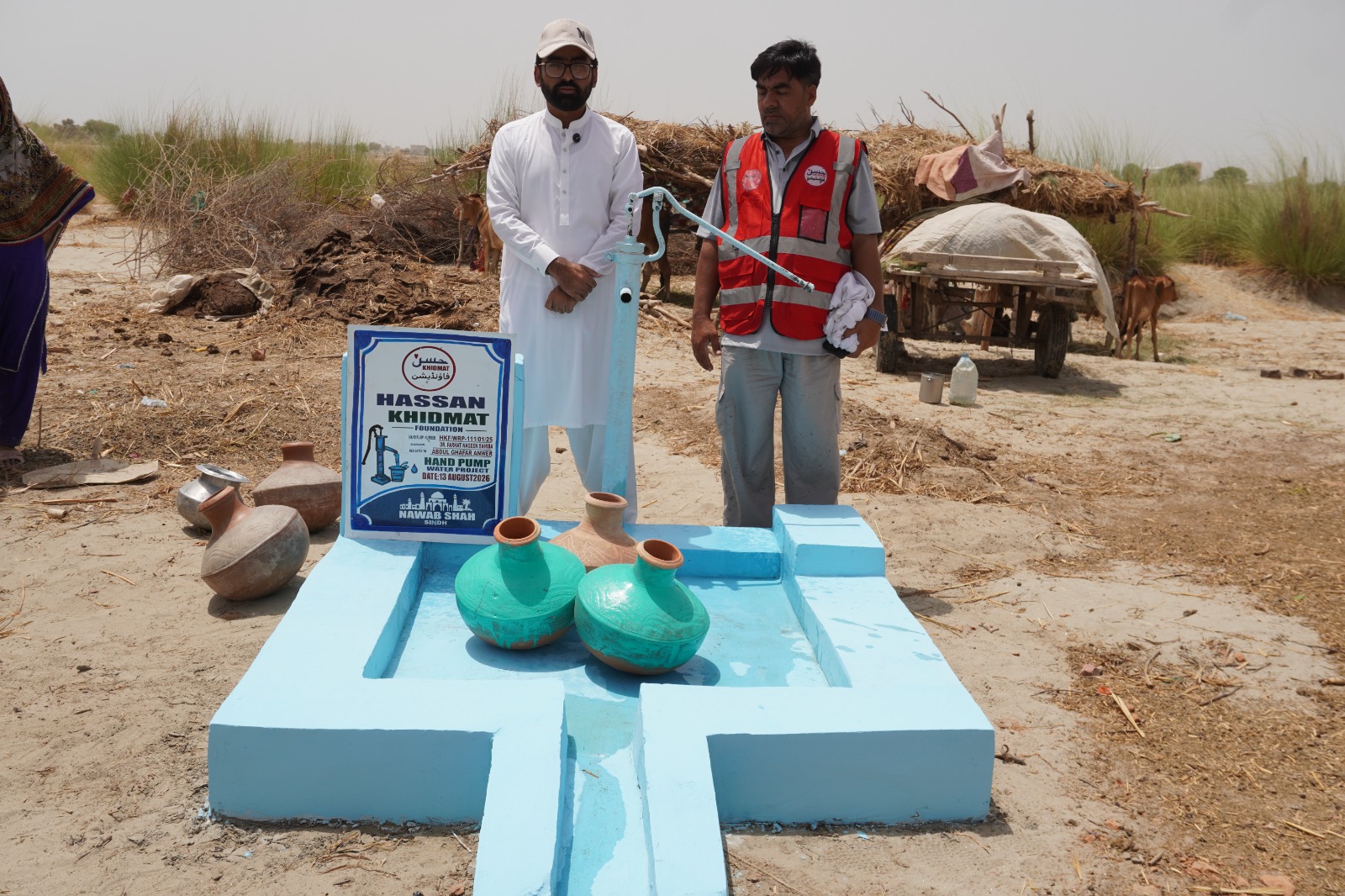 Foundation field team beside a completed hand pump