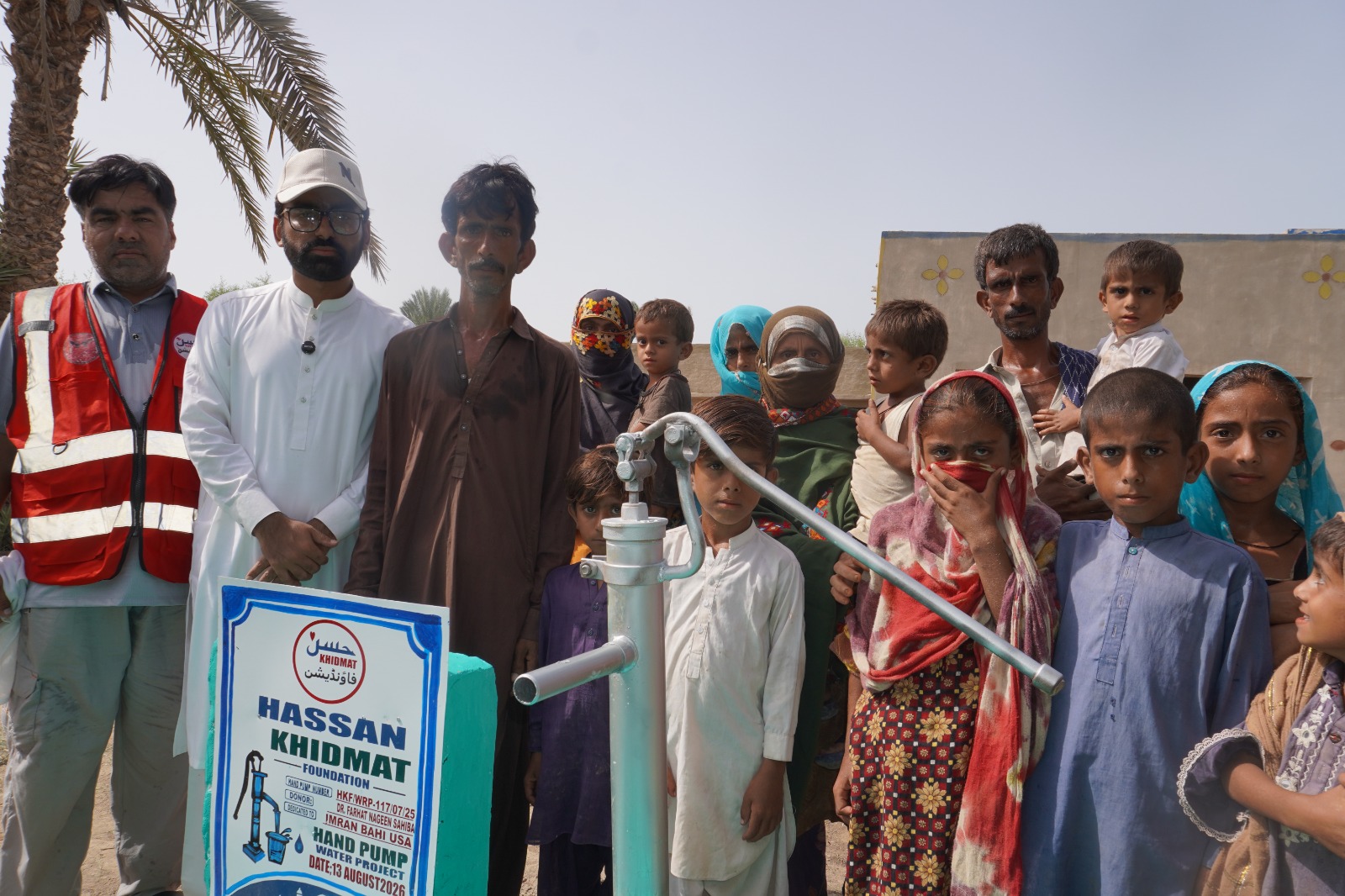 Community members using a newly installed hand pump